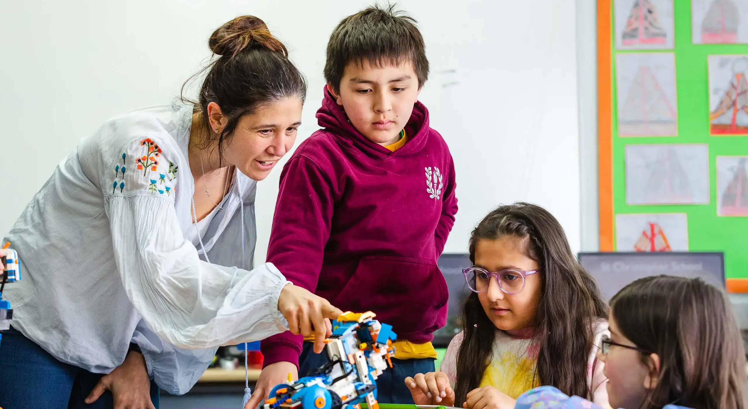 Pupils building Lego in class with teacher