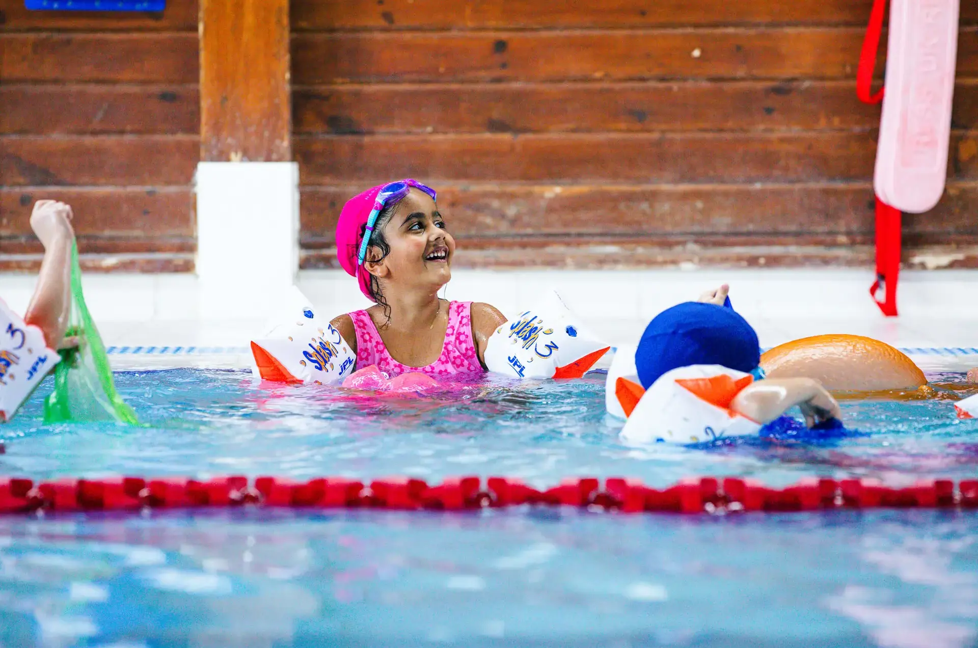 Junior School pupil enjoying swimming lesson at St Chris