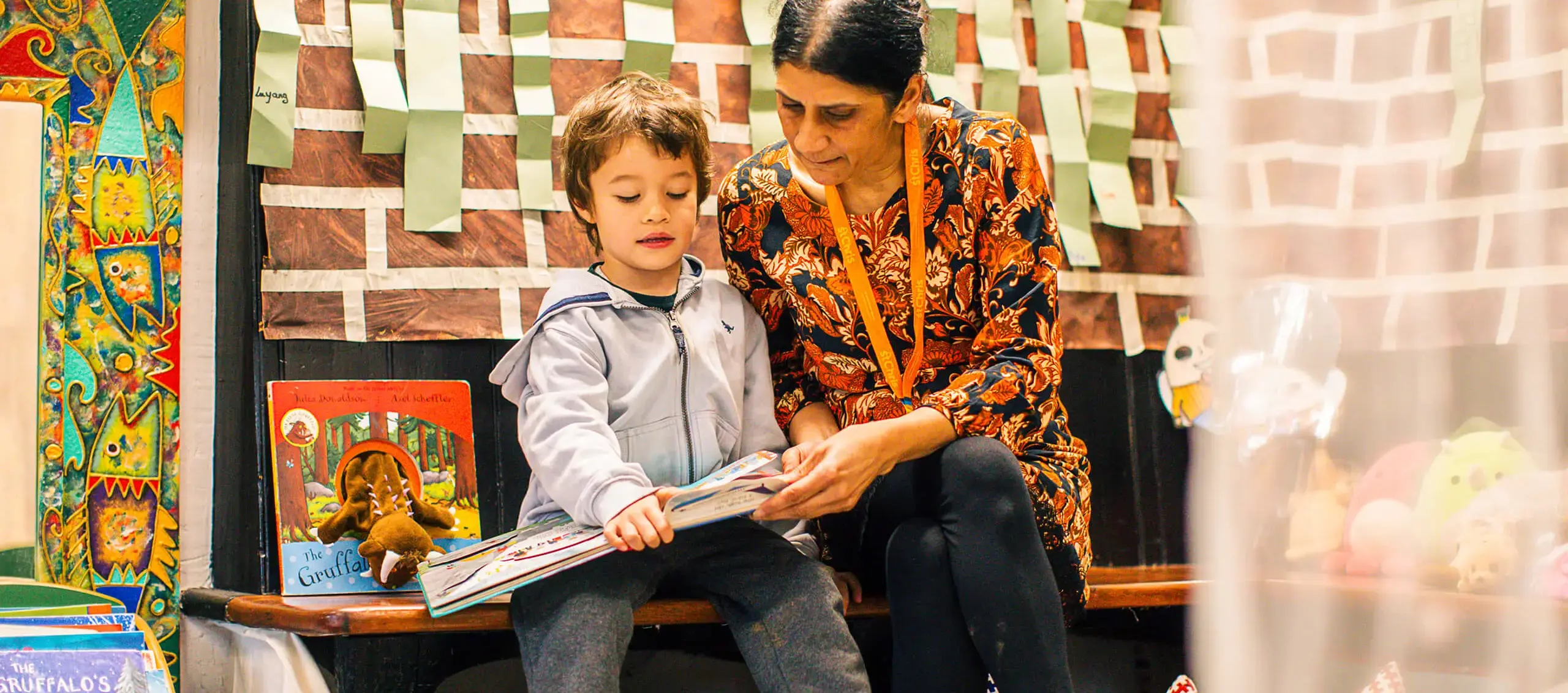 Pupil reading with teacher at St Chris
